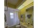 Well-lit bathroom with tub, vanity, and decorative rug at 5800 Sabal Trace Dr # 1201, North Port, FL 34287