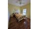 Bright bedroom with hardwood floors, a ceiling fan, and a comfortable bed at 5800 Sabal Trace Dr # 1201, North Port, FL 34287