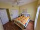 Bright bedroom with hardwood floors, a ceiling fan, and a comfortable bed at 5800 Sabal Trace Dr # 1201, North Port, FL 34287