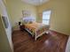 Bright bedroom with hardwood floors, a ceiling fan, and a comfortable bed at 5800 Sabal Trace Dr # 1201, North Port, FL 34287