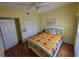 Bright bedroom with hardwood floors, a ceiling fan, and a comfortable bed at 5800 Sabal Trace Dr # 1201, North Port, FL 34287
