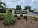Welcoming Linkside community sign with lush landscaping and a vibrant, well-maintained entrance at 5800 Sabal Trace Dr # 1201, North Port, FL 34287
