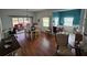 Dining area featuring wood floors, a table with seating, and a sliding glass door to the patio at 5800 Sabal Trace Dr # 1201, North Port, FL 34287