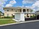 Exterior showcases a condo with covered parking, storage units, and manicured landscaping at 5800 Sabal Trace Dr # 1201, North Port, FL 34287