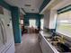 Bright eat-in kitchen area with white cabinets, tile floors, and a view to the breakfast nook at 5800 Sabal Trace Dr # 1201, North Port, FL 34287