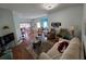 Open living room featuring hardwood floors, plush seating, and a seamless flow to dining area at 5800 Sabal Trace Dr # 1201, North Port, FL 34287