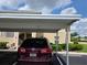 Designated parking space under cover with building number; view of condo exterior at 5800 Sabal Trace Dr # 1201, North Port, FL 34287
