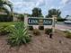 Link Side community sign amidst lush landscaping and well-maintained grounds at 5800 Sabal Trace Dr # 1201, North Port, FL 34287