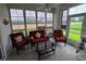 Relaxing sunroom with multiple windows, wicker furniture and view of backyard at 5800 Sabal Trace Dr # 1201, North Port, FL 34287