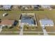 Expansive aerial shot of a property featuring a sparkling pool, verdant landscaping, and a tranquil residential neighborhood at 6286 Coniston St, Port Charlotte, FL 33981