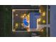 Overhead aerial view of a fenced-in backyard with a screened pool, landscaping, and backyard lighting at 6286 Coniston St, Port Charlotte, FL 33981