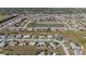 Wide aerial shot of a neighborhood with a pond; the home has a fenced in yard and a pool at 6286 Coniston St, Port Charlotte, FL 33981