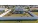 Aerial view of fenced yard with a pool and lush tropical landscaping around the screened-in patio at 6286 Coniston St, Port Charlotte, FL 33981