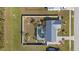 Aerial view of a fenced-in home featuring a screened pool, stylish landscaping, and a metal roof at 6286 Coniston St, Port Charlotte, FL 33981