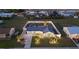 Aerial view of a single-story home with a fenced backyard and driveway lighting at 6286 Coniston St, Port Charlotte, FL 33981
