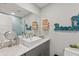 Well-lit bathroom with a modern sink, large mirror, and 