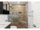 Bathroom featuring a tiled shower, a toilet and a vanity with a marble top and dark wood cabinets at 6286 Coniston St, Port Charlotte, FL 33981