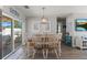 Dining room with a wooden table set, natural light, and sliding glass doors to the outdoor living space at 6286 Coniston St, Port Charlotte, FL 33981