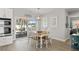 Bright dining area features natural lighting, a view of the outdoor deck, and an open flow with the kitchen at 6286 Coniston St, Port Charlotte, FL 33981