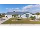 Charming home featuring lush landscaping, a well-manicured lawn, vibrant plantings, and an inviting exterior at 6286 Coniston St, Port Charlotte, FL 33981