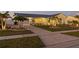 Home exterior with brick driveway, garage, and manicured landscaping at 6286 Coniston St, Port Charlotte, FL 33981