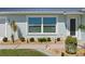 Close-up of the home's exterior with lush landscaping, rock beds, and charming details at 6286 Coniston St, Port Charlotte, FL 33981