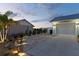 Beautiful home exterior with brick driveway, manicured landscaping, and accent lighting at 6286 Coniston St, Port Charlotte, FL 33981