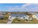 Charming single-story home featuring a modern metal roof, well-manicured lawn, and inviting landscaping at 6286 Coniston St, Port Charlotte, FL 33981