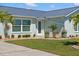 Beautiful home exterior with manicured lawn, lush landscaping, and a charming front entrance at 6286 Coniston St, Port Charlotte, FL 33981