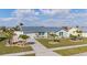 Charming single-story home with a metal roof, well-manicured lawn, palm trees and a paved driveway at 6286 Coniston St, Port Charlotte, FL 33981