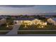 Single-story home with illuminated landscaping, driveway, and a well-maintained lawn at 6286 Coniston St, Port Charlotte, FL 33981