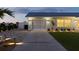 Garage exterior with manicured landscaping and walkway lighting at 6286 Coniston St, Port Charlotte, FL 33981