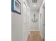 Bright hallway features wood-look floors and nautical-themed decor, enhancing the coastal charm of the home at 6286 Coniston St, Port Charlotte, FL 33981