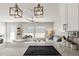 Bright and open living area with updated kitchen, offering a stylish cooktop, counters, and ample seating at 6286 Coniston St, Port Charlotte, FL 33981