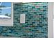 Stylish kitchen features a multicolored tile backsplash, adding texture and visual interest to the space at 6286 Coniston St, Port Charlotte, FL 33981