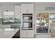 Bright kitchen featuring modern stainless steel appliances and a sliding glass door to the outdoor patio at 6286 Coniston St, Port Charlotte, FL 33981