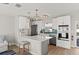 Modern kitchen featuring white cabinets, quartz countertops, stainless steel appliances, and stylish pendant lighting at 6286 Coniston St, Port Charlotte, FL 33981