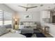 Bright living room with ceiling fan, sofa, and a nautical theme rug; open to a kitchen area at 6286 Coniston St, Port Charlotte, FL 33981