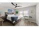 Cozy bedroom with a wooden bed frame, a ceiling fan, a desk, and natural light at 6286 Coniston St, Port Charlotte, FL 33981