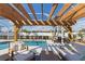 Inviting outdoor area with covered pergola, comfortable seating, and a sparkling swimming pool at 6286 Coniston St, Port Charlotte, FL 33981