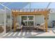 Inviting outdoor patio area with pergola offering shade, comfortable seating, and easy access to the pool at 6286 Coniston St, Port Charlotte, FL 33981