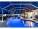 Stunning screened-in pool with lighting and a covered patio area, perfect for evening swims at 6286 Coniston St, Port Charlotte, FL 33981