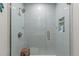 Glass-enclosed shower with blue subway tile, a built-in niche, a bench, and modern fixtures at 6286 Coniston St, Port Charlotte, FL 33981