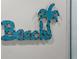 Fun wall decor displays a 'Beach' sign and palm tree accent, enhancing the coastal theme at 6286 Coniston St, Port Charlotte, FL 33981