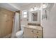 Cozy bathroom featuring a shower with a shower curtain and a vanity with granite countertops at 6841 46Th N St, Pinellas Park, FL 33781