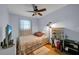 Cozy bedroom featuring a ceiling fan, natural light, and laminate wood flooring at 6841 46Th N St, Pinellas Park, FL 33781