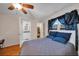 Bedroom with a bed, wood floors, a ceiling fan and ensuite bath and walk-in closet at 6841 46Th N St, Pinellas Park, FL 33781