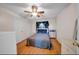 Bedroom with hardwood floors, ceiling fan, and neutral decor, creating a calming atmosphere at 6841 46Th N St, Pinellas Park, FL 33781
