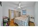 Bright bedroom with wood floors, bi-fold closet doors, and a ceiling fan at 6841 46Th N St, Pinellas Park, FL 33781