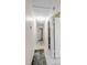Hallway with tile flooring, neutral wall color, and doors leading to various rooms at 6841 46Th N St, Pinellas Park, FL 33781